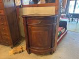 a wooden cabinet with a mirror on top of it