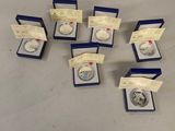 a group of silver coins in a blue box on a table