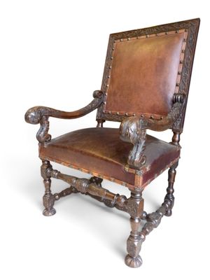an image of a chair with a leather seat and wood frame