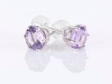 a pair of earrings with amethorate stones on a white background