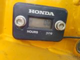 a close up of a digital clock on a yellow vehicle