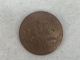 a close up of a coin with a picture of a man and a woman on it