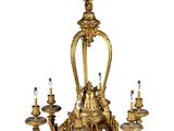 a gold colored chandelier with five lights hanging from it
