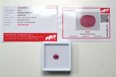 a pink diamond in a white box on a table