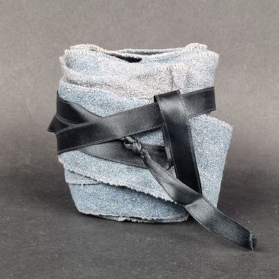 an image of a stack of towels with a leather strap