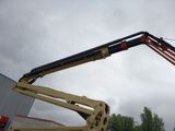 a picture of a man on a cherry picker in a parking lot