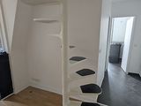 a white spiral staircase in the middle of a room