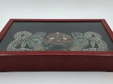 a close up of a wooden box with a snake on it