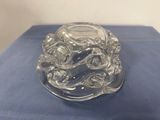 an image of a clear glass candle holder sitting on a blue cloth