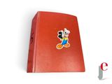 mickey mouse pin on a red book with a white background