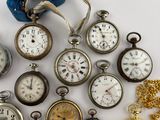 many different types of pocket watches on the table