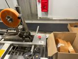 a machine that has a roll of tape on it