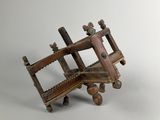 an old wooden model of a plane with wheels on a white background