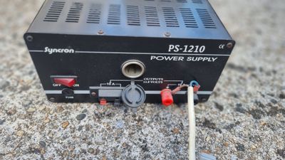 a close up of a power supply sitting on a concrete surface