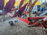 a lot of red chairs that are sitting in the dirt