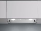 an image of a white kitchen with a stove top oven and a range hood