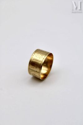 a close up of a gold ring on a white surface