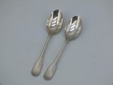 two spoons that are sitting on a plate
