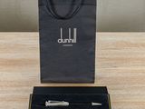 the pen is sitting in the black box on the table