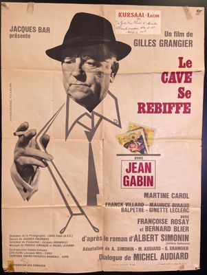 poster of a man in a hat and tie smoking a cigarette