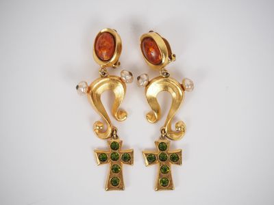 a pair of gold earrings with green and red stones