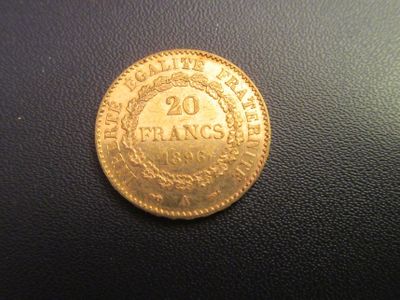 a close up of a gold coin on a black surface