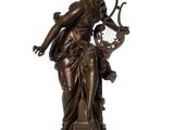 a bronze statue of a woman holding a harp