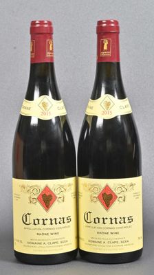 two bottles of red wine sitting next to each other on a table