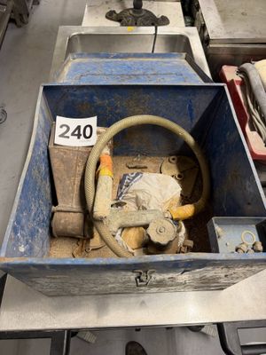 a blue box with a hose in it sitting on a table