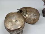 two metal objects sitting next to each other on a table