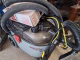 a vacuum that is sitting on the floor in the garage