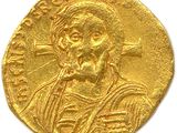 a close up of a gold coin with a man on it