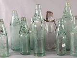 a lot of glass bottles that are sitting on a table