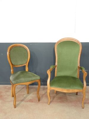 two green chairs sitting next to each other in a room