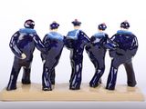 four figurines of men dressed in blue uniforms