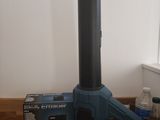 a blue blower sitting on a wooden floor next to a bottle of water