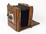 an old wooden camera that is sitting on a table