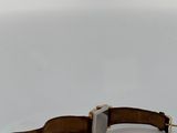 an image of a watch sitting on top of a white surface