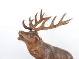a wooden sculpture of a deer with antlers on it ' s head