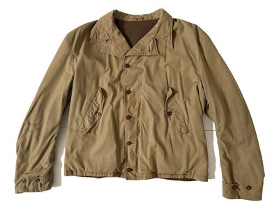 the jacket is tan and has buttons on the collar