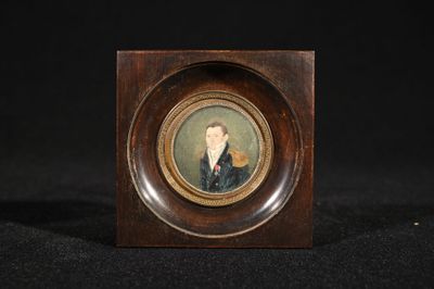 an old picture of a man in a suit and tie in a wooden frame