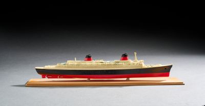 une petite maquette de bateau posée sur un socle en bois