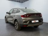 the rear view of a grey car parked in a showroom