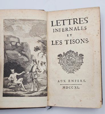 un livre ouvert sur lequel figure l'image d'un homme et d'un enfant dans une grotte
