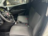 l'intérieur d'une petite camionnette, la porte ouverte et le siège conducteur rabattu