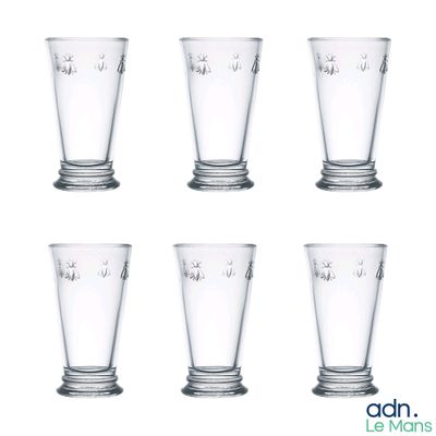 six glasses of different sizes are lined up on a white surface