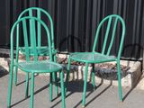three green chairs sitting next to each other in front of a black wall