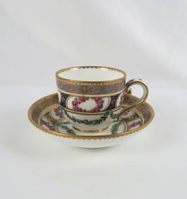 tea cup and saucer decorated with flowers on a white background