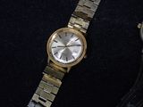 a watch that is sitting on a black surface