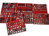 many different types of watches displayed in a red case